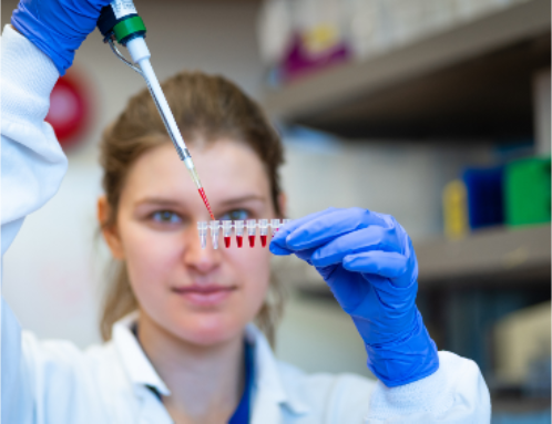 A researcher in a laboratory handling a syringe for injectable allergen immunotherapy (SCIT)